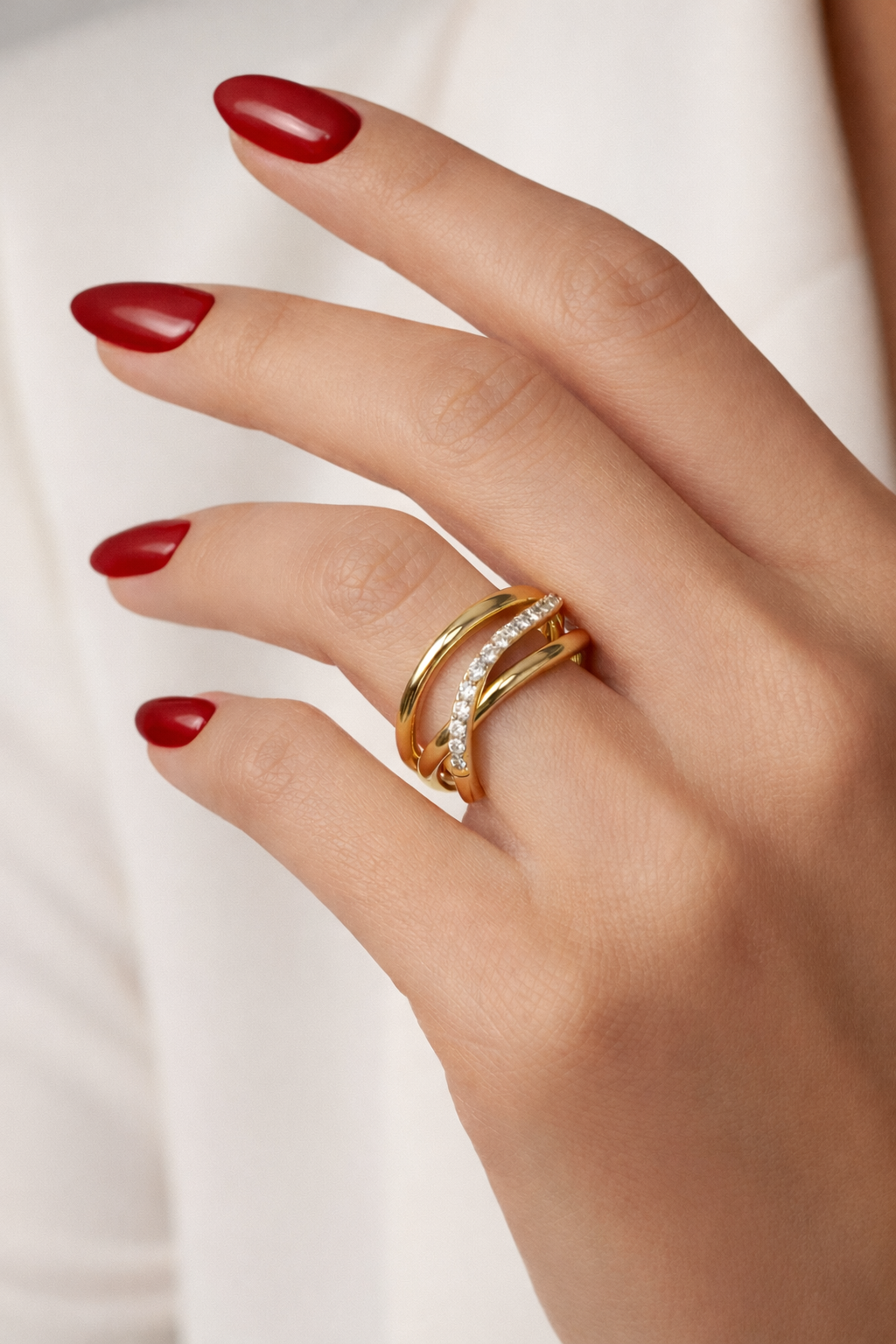 Macro close-up of the shimmering zircon stones set along the curved wave for added sparkle and refinement.