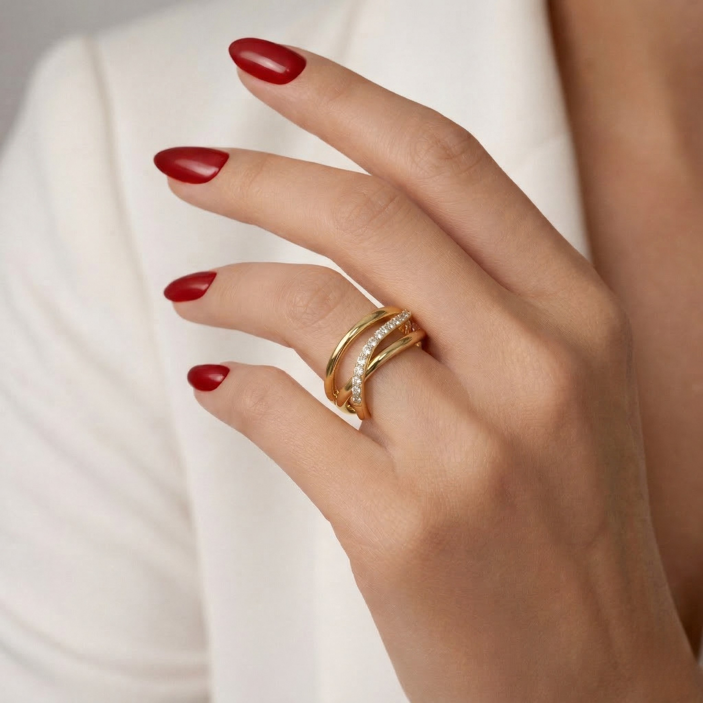 Macro close-up of the shimmering zircon stones set along the curved wave for added sparkle and refinement.