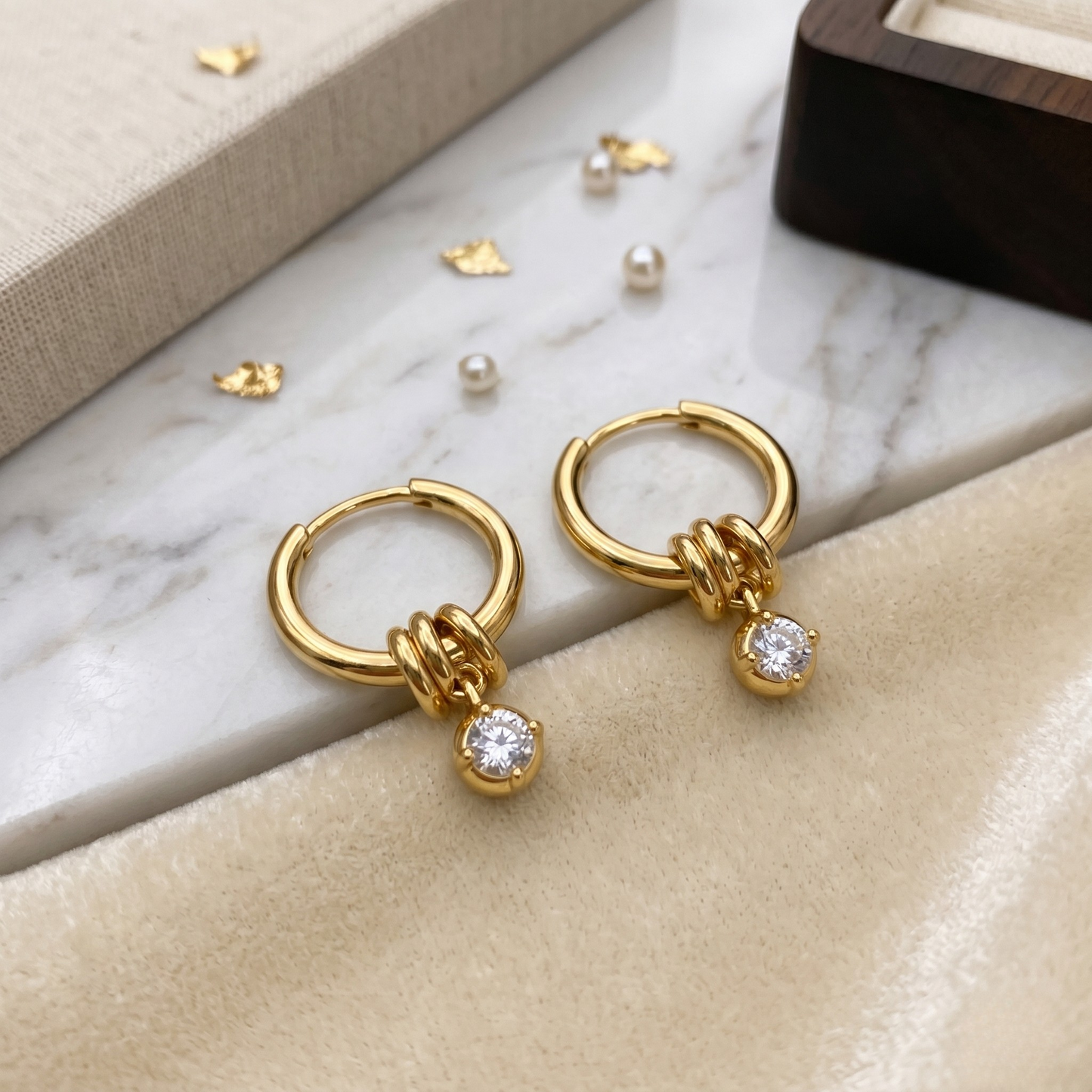 Pair view of Barbara fine jewelry hoop earrings, showcasing their polished gold finish, balanced proportions, and zircon detail.