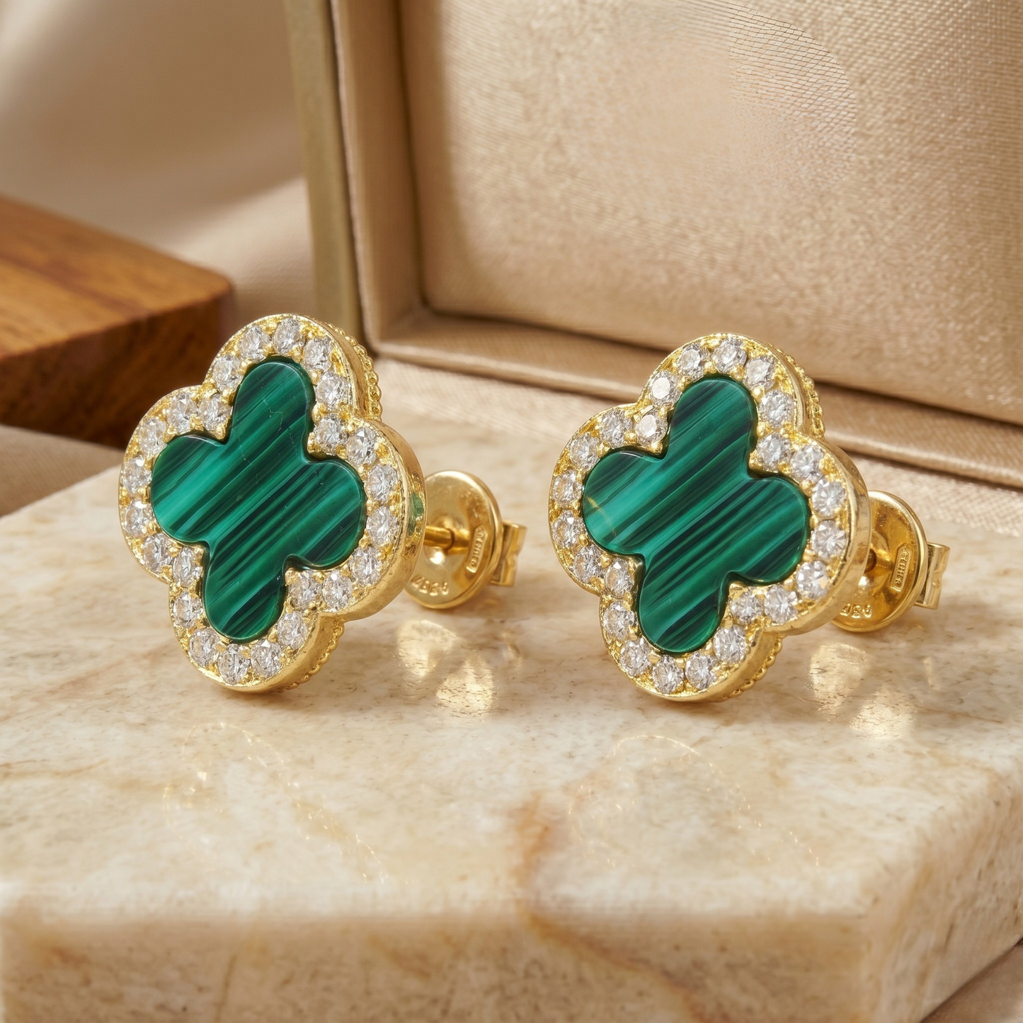 Pair of clover stud earrings crafted from sterling silver and gold plating, highlighting elegant proportions and luxury design.