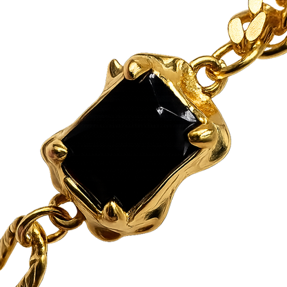 Detailed angle highlighting the polished gold-plated finish and sculptural stone setting.