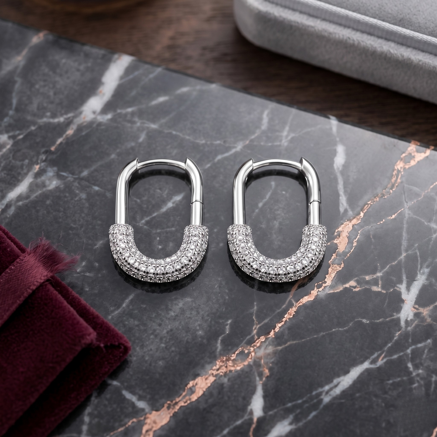Sophisticated Ada Hoop Earrings in S925 sterling silver with premium rhodium plating, designed with a sleek oval hoop silhouette and brilliant pavé zircon detailing for radiant sparkle. These hypoallergenic silver statement earrings offer timeless elegance, tarnish resistance, and versatile luxury—perfect for elevating everyday outfits or adding refined shine to special occasion styling.