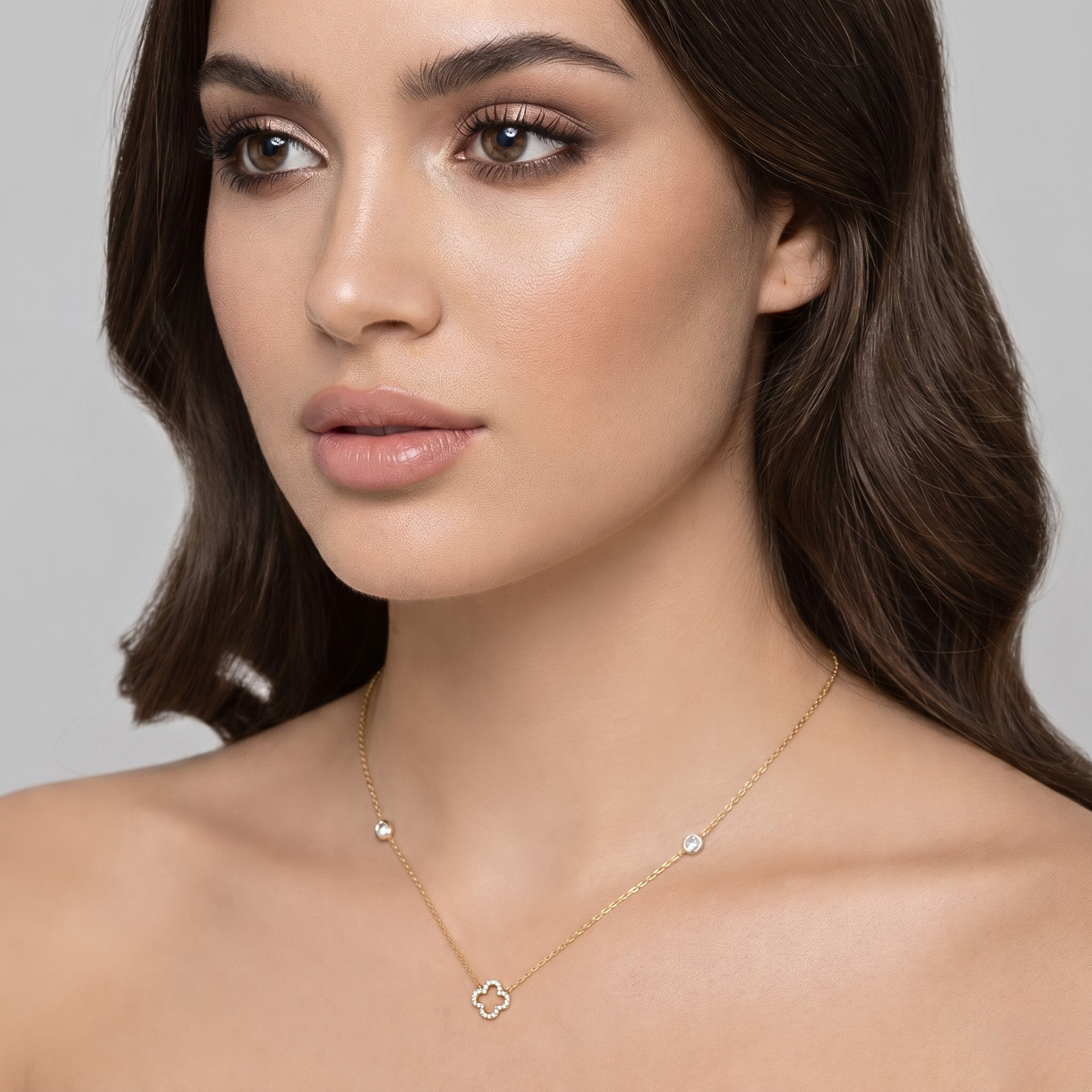 Front view of the sterling silver necklace featuring a 14K gold plated clover pendant fully set with brilliant zircon stones and accented chain details. A timeless fine jewelry piece perfect for elegant everyday styling or special occasion wear.