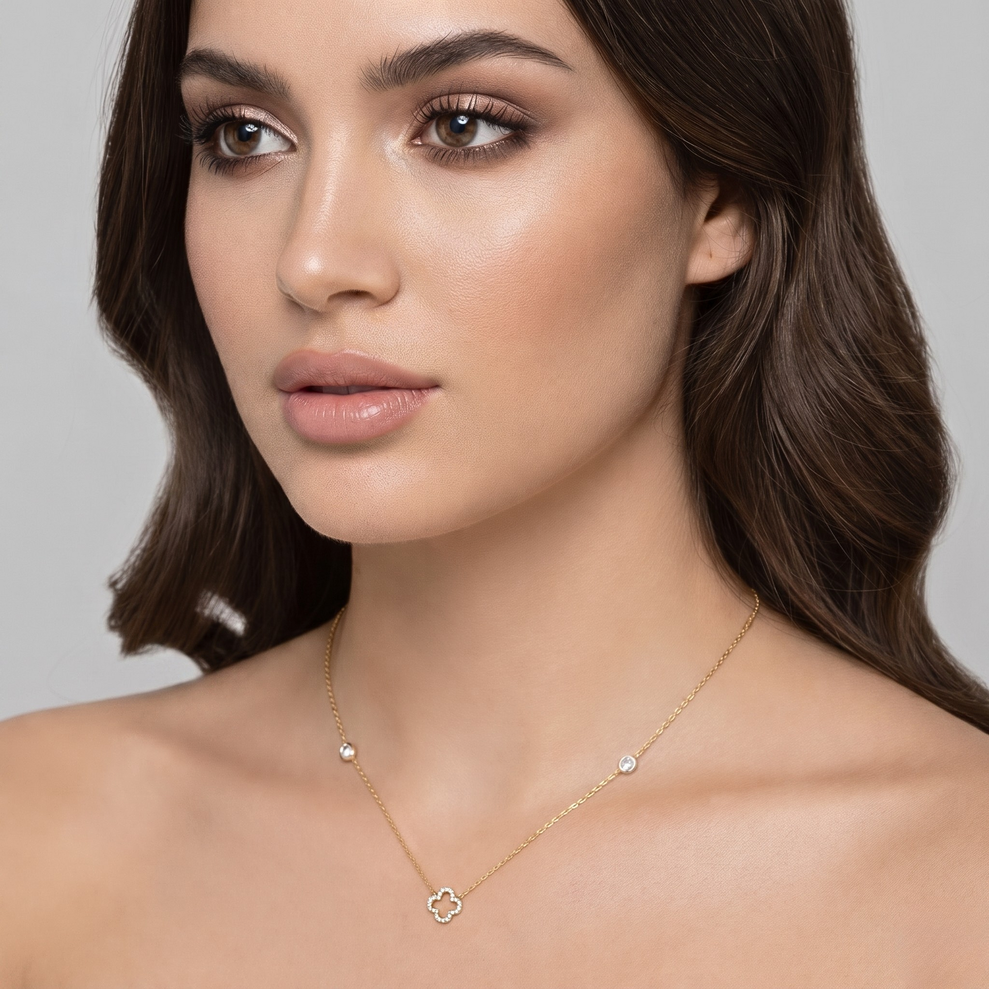 Front view of the sterling silver necklace featuring a 14K gold plated clover pendant fully set with brilliant zircon stones and accented chain details. A timeless fine jewelry piece perfect for elegant everyday styling or special occasion wear.