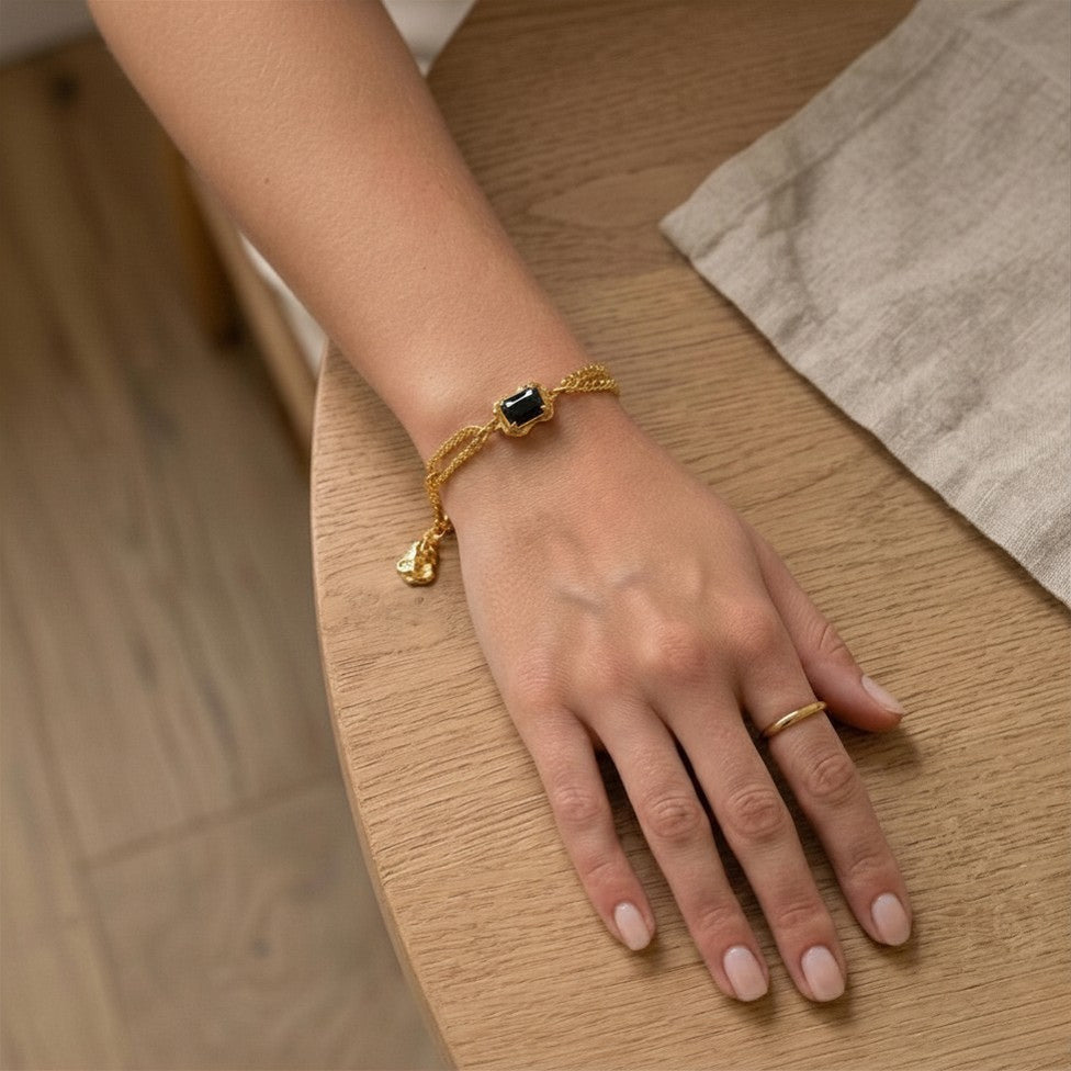 Styled product image emphasizing the bold contrast of deep black onyx and warm gold tones.