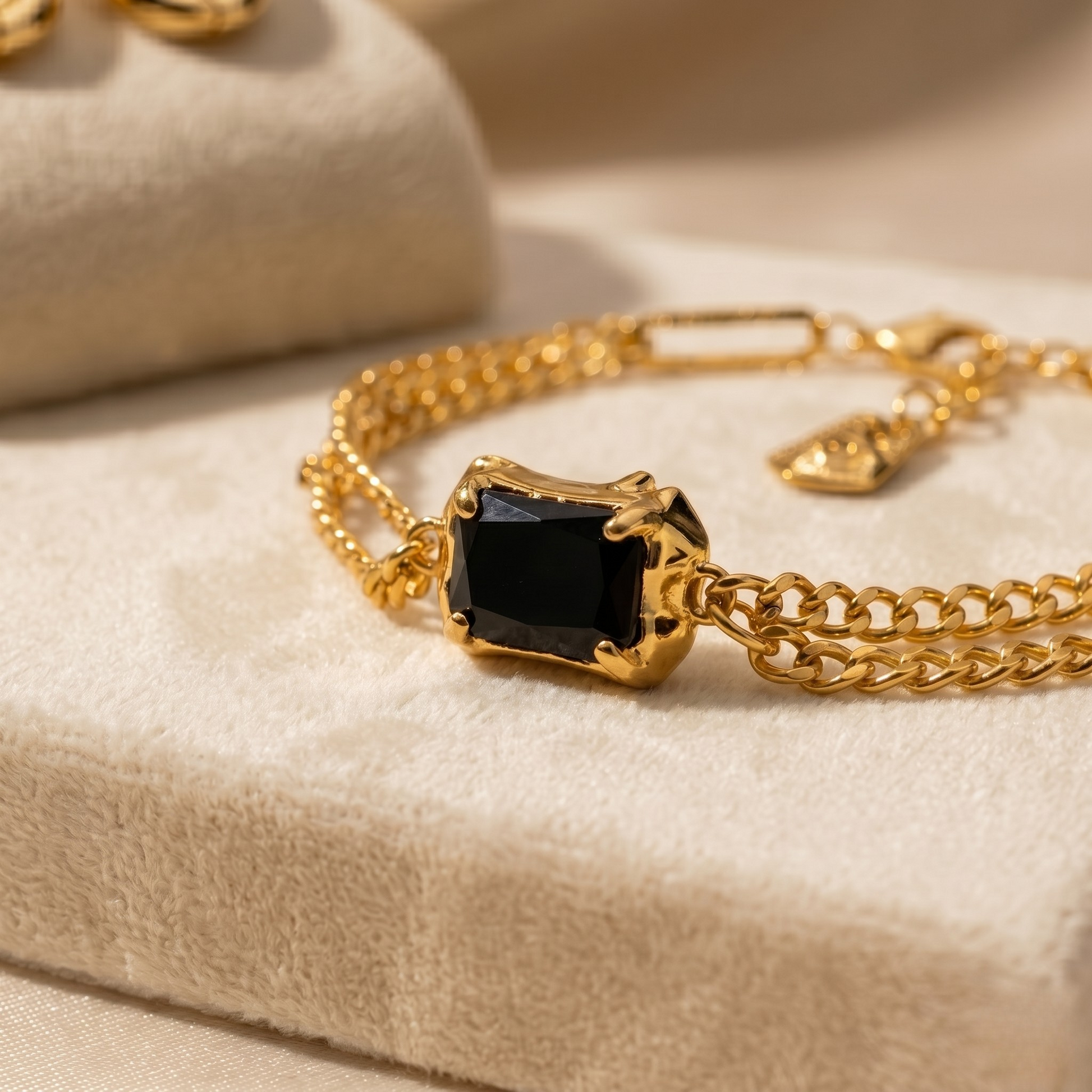 Styled product image emphasizing the bold contrast of deep black onyx and warm gold tones.