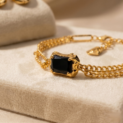 Styled product image emphasizing the bold contrast of deep black onyx and warm gold tones.