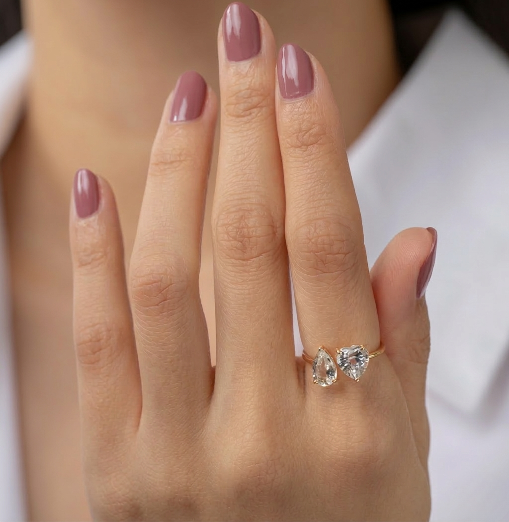 Side angle of the Natalie open design ring showing the adjustable sterling silver band with 14K gold plating and brilliant zircon stones.