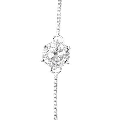 Macro close-up of the 1 carat round brilliant moissanite, emphasizing its fire, brilliance, and premium prong setting craftsmanship.