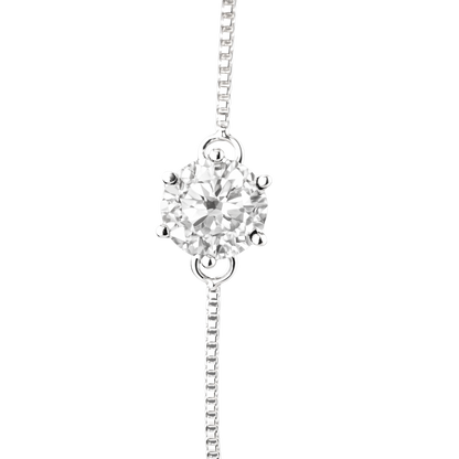 Macro close-up of the 1 carat round brilliant moissanite, emphasizing its fire, brilliance, and premium prong setting craftsmanship.