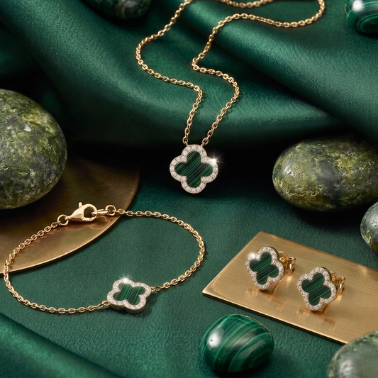 Close-up detail of the clover charm highlighting the polished 18K gold plating and brilliant zircon accents.