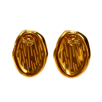 Vintage jewelry style earrings featuring a satin oval centerpiece and textured braided gold plated border. These modern jewelry statement earrings resemble cat eye earrings and tiger eye earrings, crafted as stainless steel earrings for durability and hypoallergenic jewelry comfort.