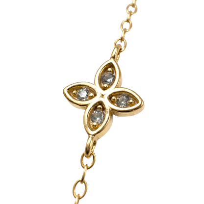 Close-up of delicate floral station details on this hypoallergenic gold plated silver bracelet.