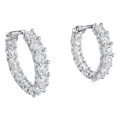 Close-up of GRA certified moissanite diamonds with VVS1 clarity set in rhodium plated silver hoops.