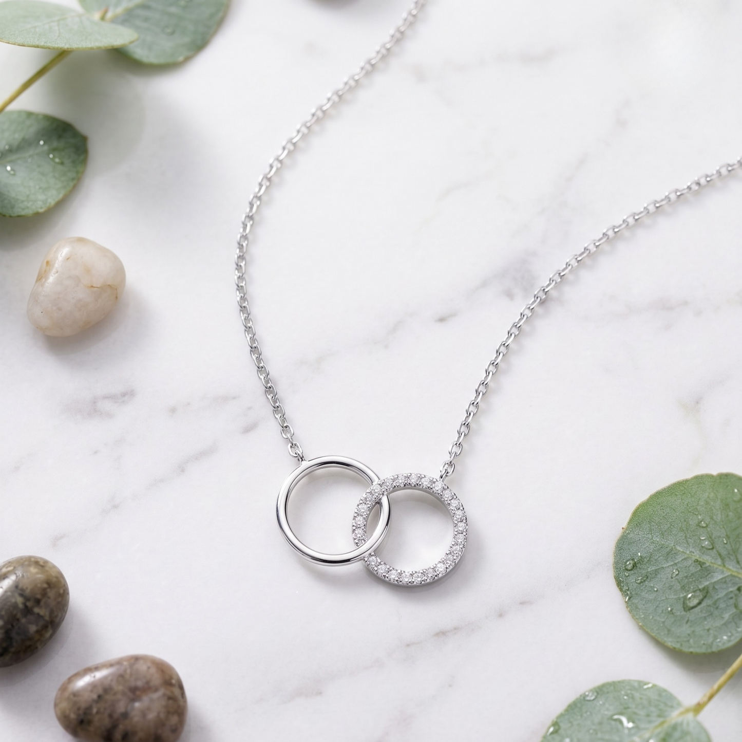 Elegant close-up of Anna double circle sterling silver necklace with rhodium plated finish and sparkling zircon accents, showcasing timeless silver jewelry sophistication.