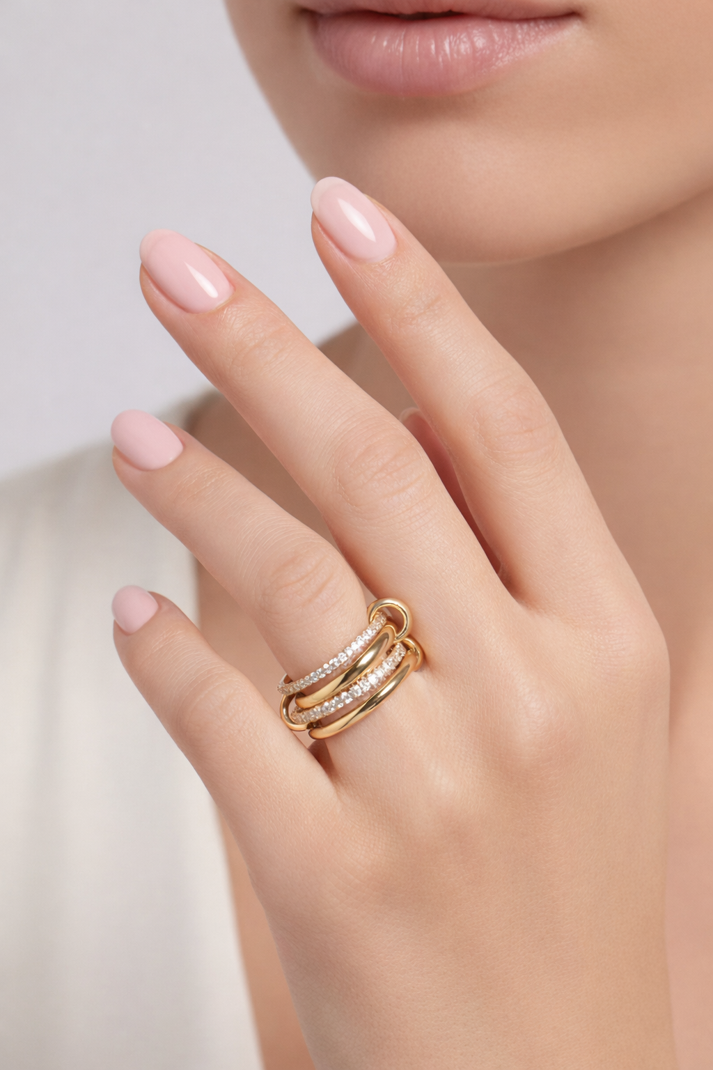 Close-up of intertwined bands and sparkling zircon stones on Ashley multi-layer ring.