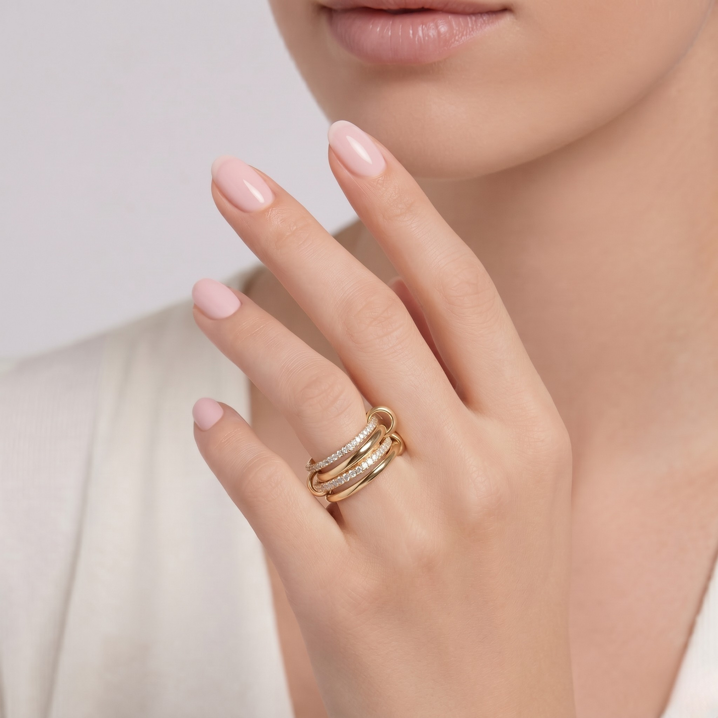 Close-up of intertwined bands and sparkling zircon stones on Ashley multi-layer ring.