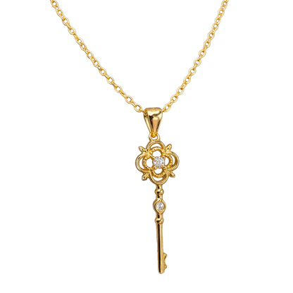Close-up detail of zircon stones on the clover and key pendant of this sterling silver 14k gold plated necklace jewelry.