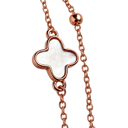 Close-up detail of hypoallergenic rose gold plated silver bracelet showcasing green stone and shell clover inlays.
