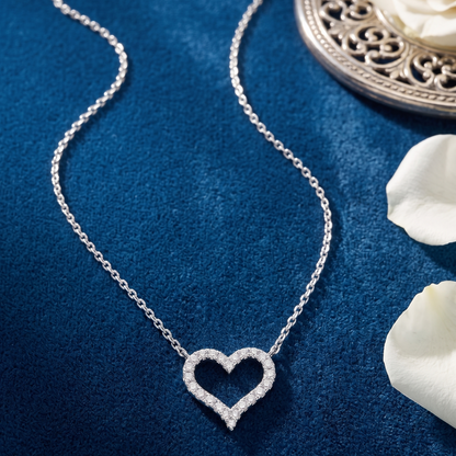 Sarah sterling silver moissanite heart necklace worn on model, showing delicate size, VVS D color brilliance, and elegant jewelry styling.