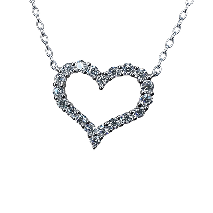 Close-up of heart pendant showing pavé moissanite stones, sterling silver base, rhodium plating, and brilliant diamond-like sparkle.
