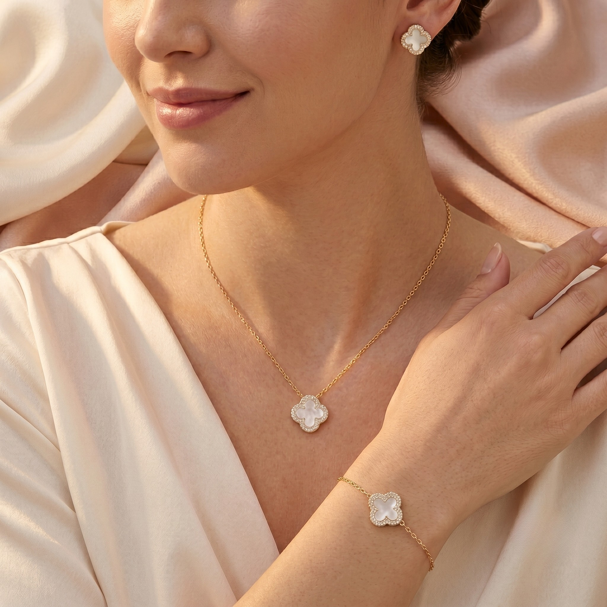 White mother of pearl clover jewelry set including sterling silver necklace, bracelet, and stud earrings. Elegant S925 silver jewelry set with zircon accents and 18K gold plating.