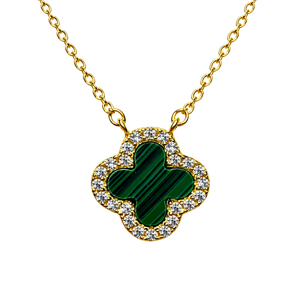 Close up of green clover pendant surrounded by sparkling zircon on 18k gold plated sterling silver necklace.