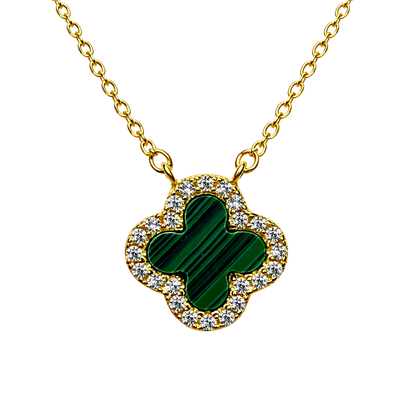 Close up of green clover pendant surrounded by sparkling zircon on 18k gold plated sterling silver necklace.