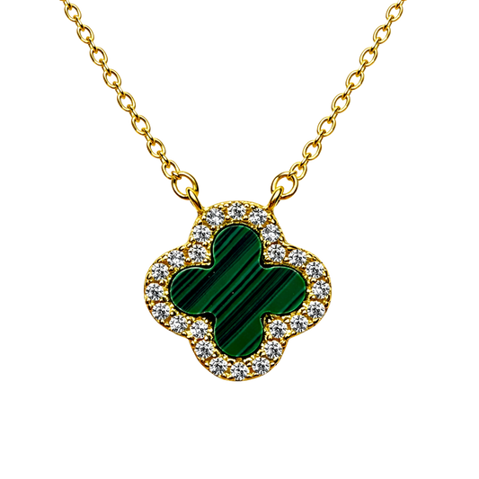 Close up of green clover pendant surrounded by sparkling zircon on 18k gold plated sterling silver necklace.