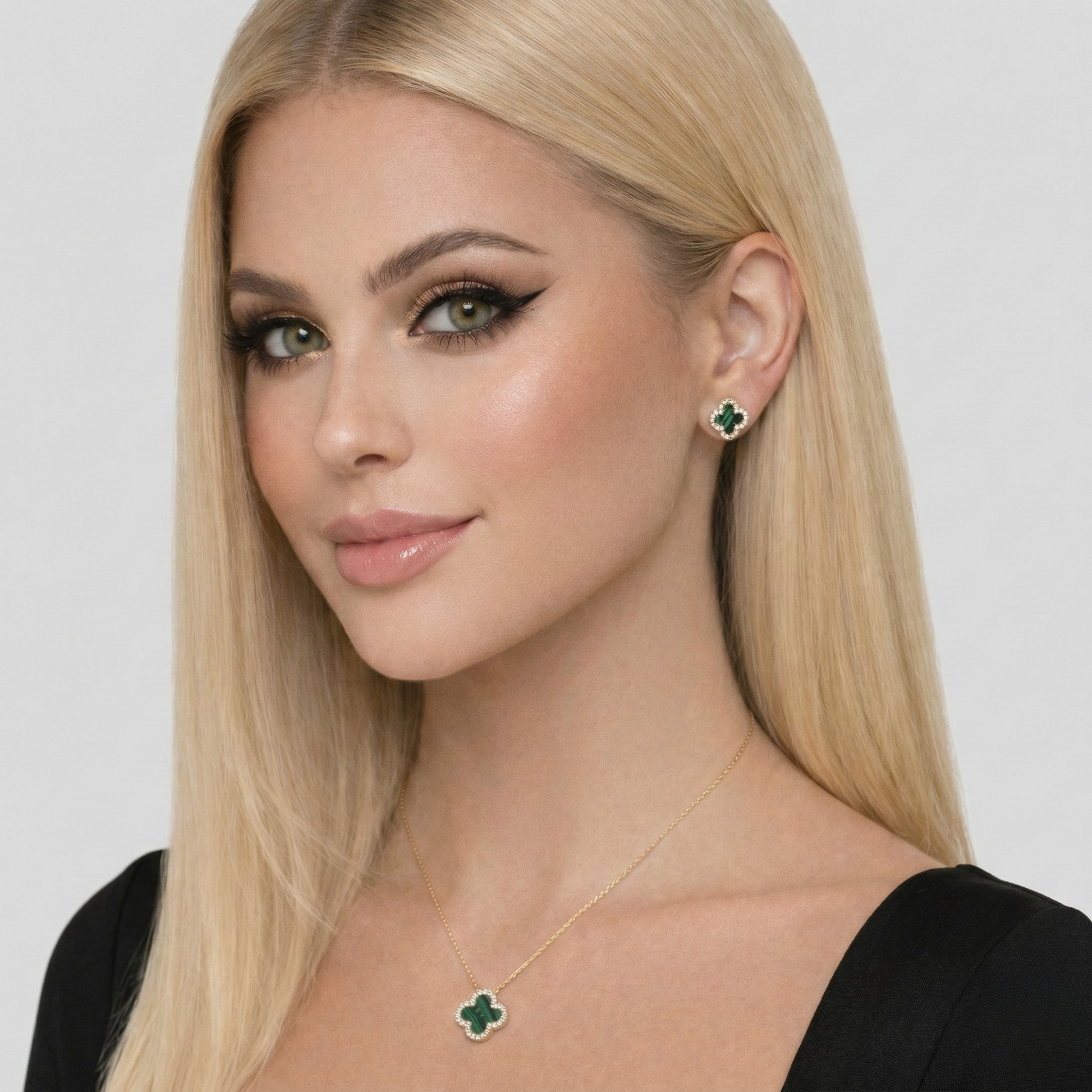 Detailed view of S925 sterling silver earrings with 18K gold plating, malachite center, and zircon halo in clover shape.